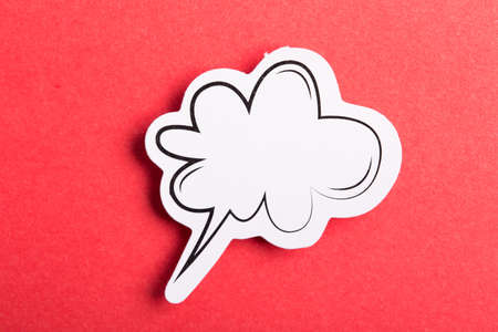 Blank white speech bubble isolated on red background.の写真素材