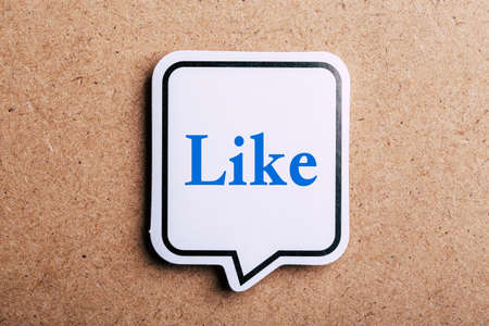 Like Concept speech bubble isolated on brown paper background with shadow.の写真素材