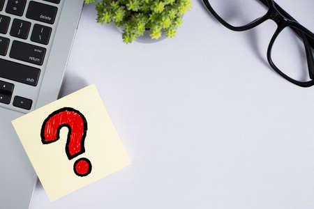 Topview of office desktop with red question mark.の写真素材