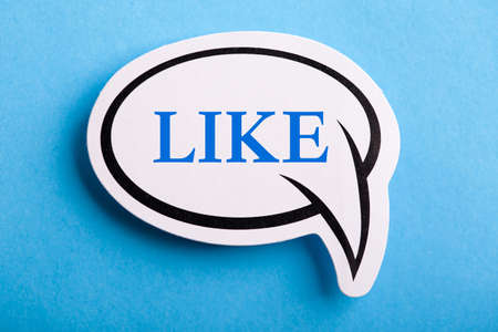 Like text speech bubble isolated on blue background.の写真素材