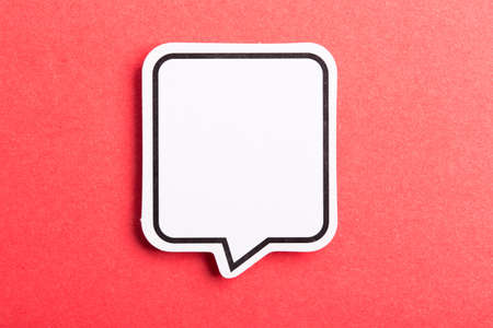 Blank white speech bubble isolated on red background.の写真素材