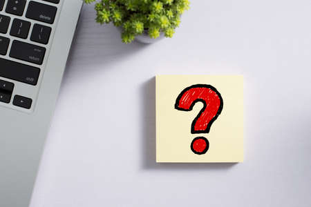 Top view of office desktop with red question mark.の写真素材
