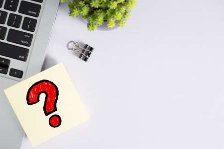 Top view of office desktop with red question mark.の写真素材