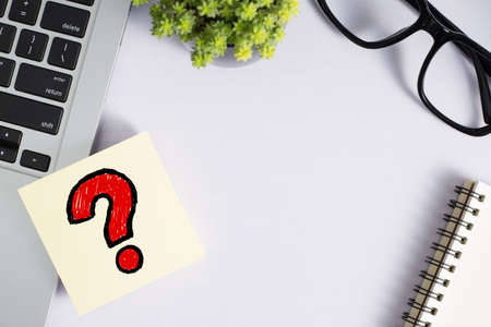 Top view of office desktop with red question mark.の写真素材