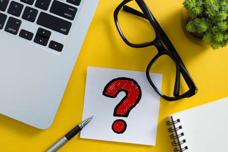 Topview of office desktop with red question mark.の写真素材