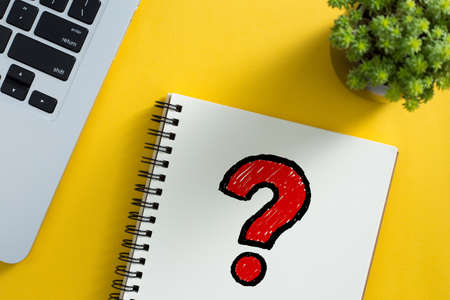Topview of office desktop with red question mark.の写真素材