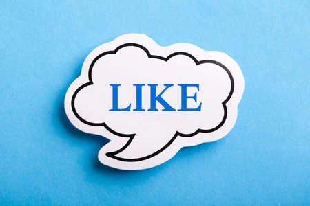 Like text speech bubble isolated on blue background.の写真素材