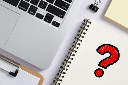Top view of office desktop with red question mark.の写真素材