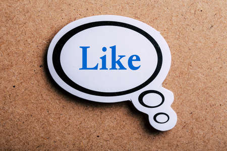 Like Concept speech bubble isolated on brown paper background with shadow.の写真素材