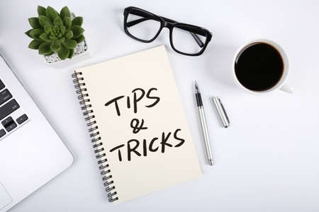 Tips And Tricks concept on desktop workspace with office supplies.の写真素材