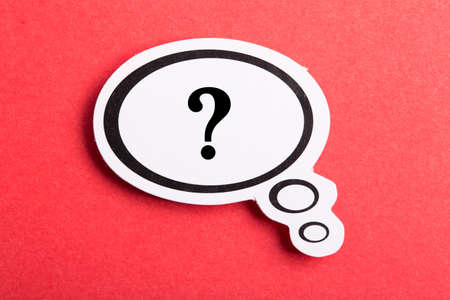 Question mark speech bubble isolated on red background.の写真素材