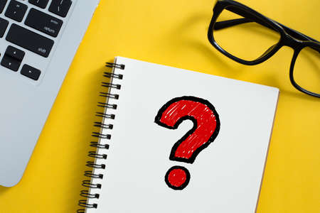 Topview of office desktop with red question mark.の写真素材