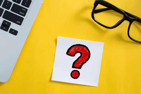 Topview of office desktop with red question mark.の写真素材