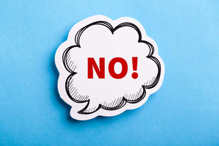 Say No white speech bubble isolated on blue background.の写真素材