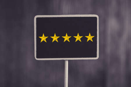 Five yellow stars concept black sign billboard isolated.の写真素材