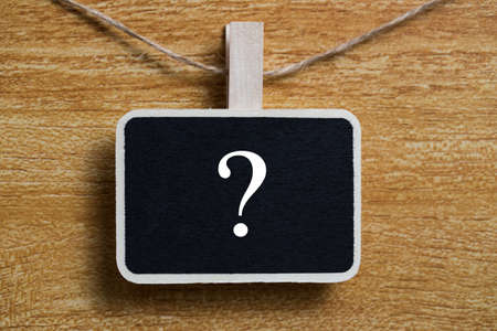 White chalk question mark on the black sign board.の写真素材
