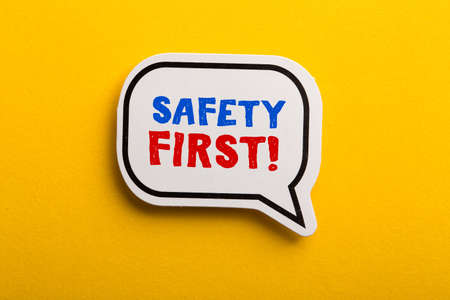 Safety first concept speech bubble isolated on yellow background.の写真素材