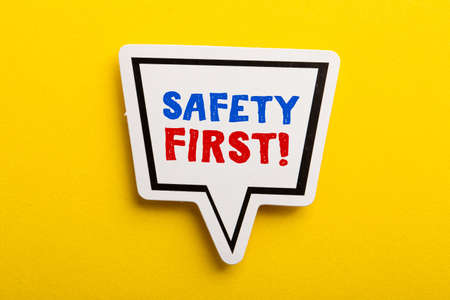 Safety first concept speech bubble isolated on yellow background.の写真素材