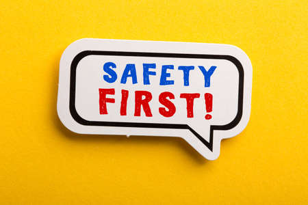 Safety first concept speech bubble isolated on yellow background.の写真素材