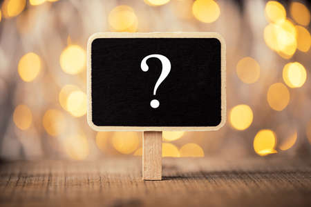 White chalk question mark on the black sign board.の写真素材
