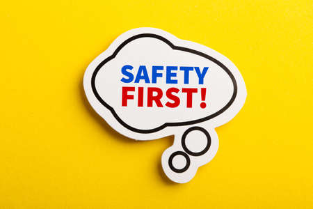 Safety first concept speech bubble isolated on yellow background.の写真素材
