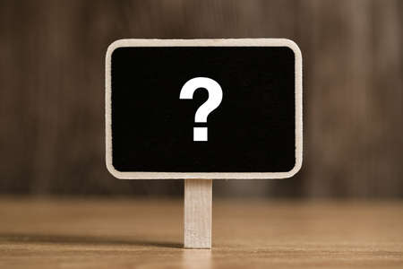 White chalk question mark on the black sign board.の写真素材