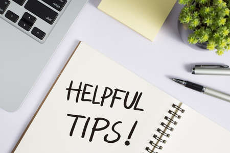 Helpful Tips concept on desktop workspace with office supplies.の写真素材