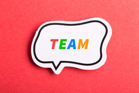 Team colorful text speech bubble isolated on red background about Teamwork concept.の写真素材