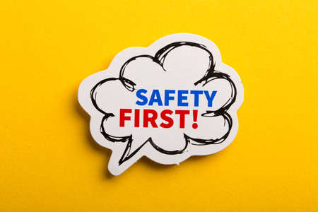 Safety first concept speech bubble isolated on yellow background.の写真素材