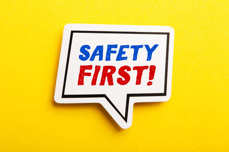 Safety first concept speech bubble isolated on yellow background.の写真素材
