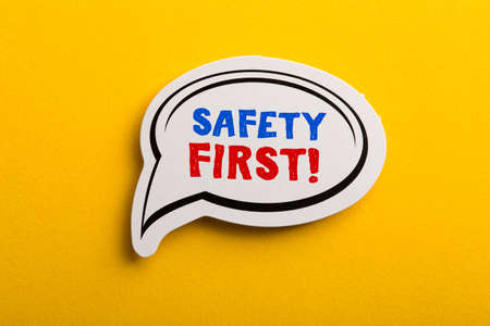 Safety first concept speech bubble isolated on yellow background.の写真素材