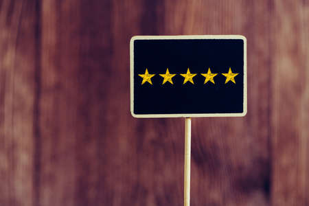Five yellow stars concept black sign billboard isolated.の写真素材