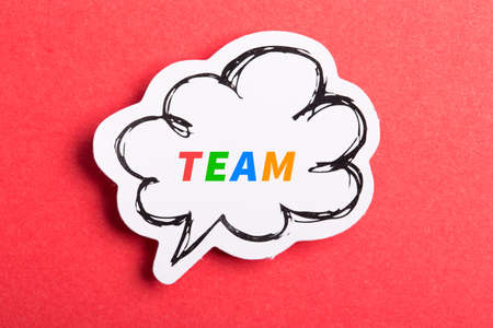 Team colorful text speech bubble isolated on red background about Teamwork concept.の写真素材