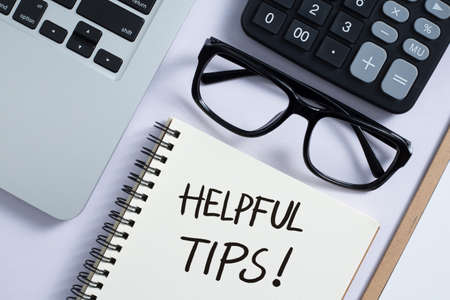 Helpful Tips concept on desktop workspace with office supplies.の写真素材