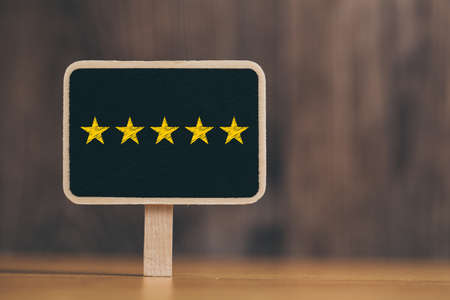Five yellow stars concept black sign billboard isolated.の写真素材