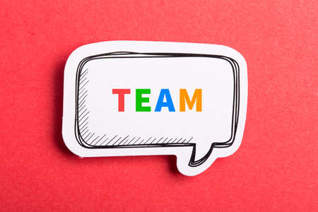 Team colorful text speech bubble isolated on red background about Teamwork concept.の写真素材