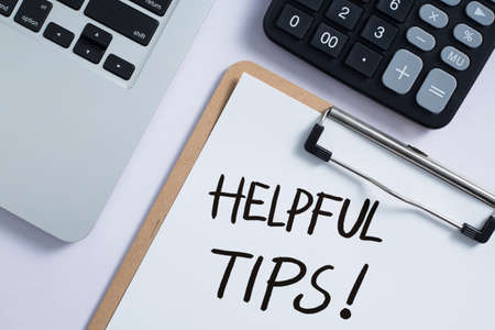 Helpful Tips concept on desktop workspace with office supplies.の写真素材
