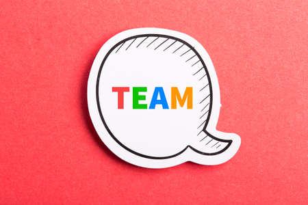 Team colorful text speech bubble isolated on red background about Teamwork concept.の写真素材