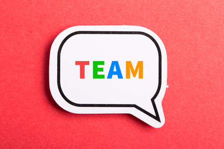 Team colorful text speech bubble isolated on red background about Teamwork concept.の写真素材