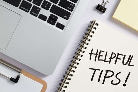 Helpful Tips concept on desktop workspace with office supplies.の写真素材