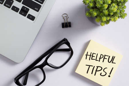 Helpful Tips concept on desktop workspace with office supplies.の写真素材