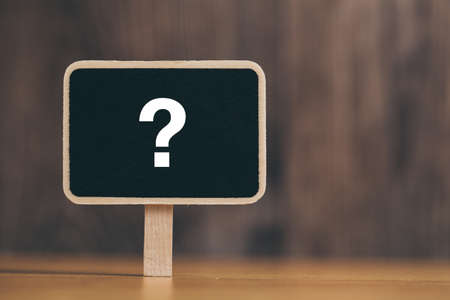 White chalk question mark on the black sign board.の写真素材