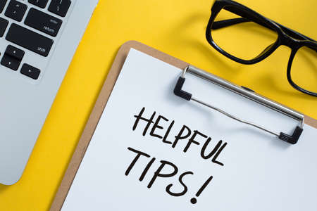 Helpful Tips concept on desktop workspace with office supplies.の写真素材