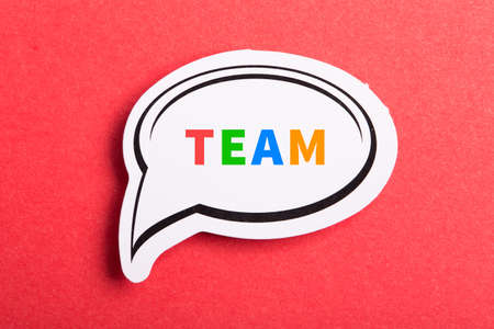 Team colorful text speech bubble isolated on red background about Teamwork concept.の写真素材