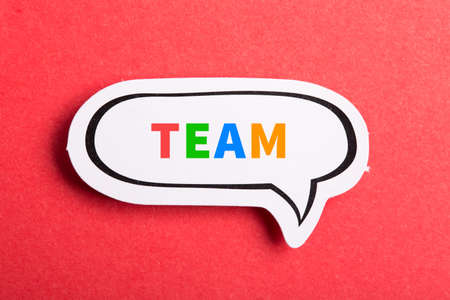 Team colorful text speech bubble isolated on red background about Teamwork concept.の写真素材