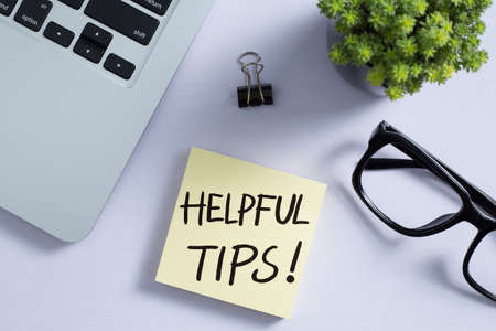 Helpful Tips concept on desktop workspace with office supplies.の写真素材
