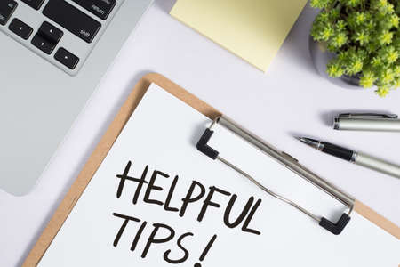 Helpful Tips concept on desktop workspace with office supplies.の写真素材