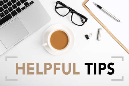 Helpful Tips concept on desktop workspace with office supplies.の写真素材