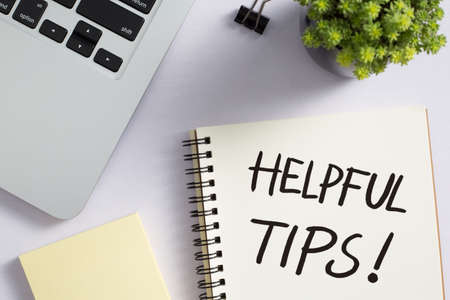 Helpful Tips concept on desktop workspace with office supplies.の写真素材