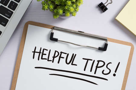 Helpful Tips concept on desktop workspace with office supplies.の写真素材